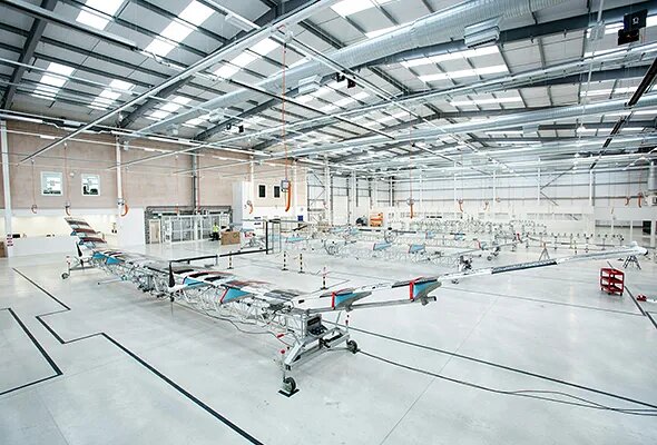 A high-altitude pseudo-satellite (HAPS) research aircraft under assembly in a production hangar